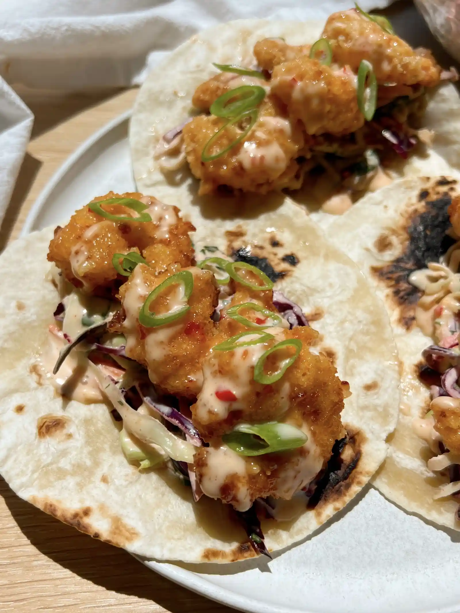 Air Fryer Bang Bang Shrimp Tacos Recipe 2 Crispy Air Fryer Bang Bang Shrimp Tacos served on flour tortillas with cabbage slaw and fresh cilantro