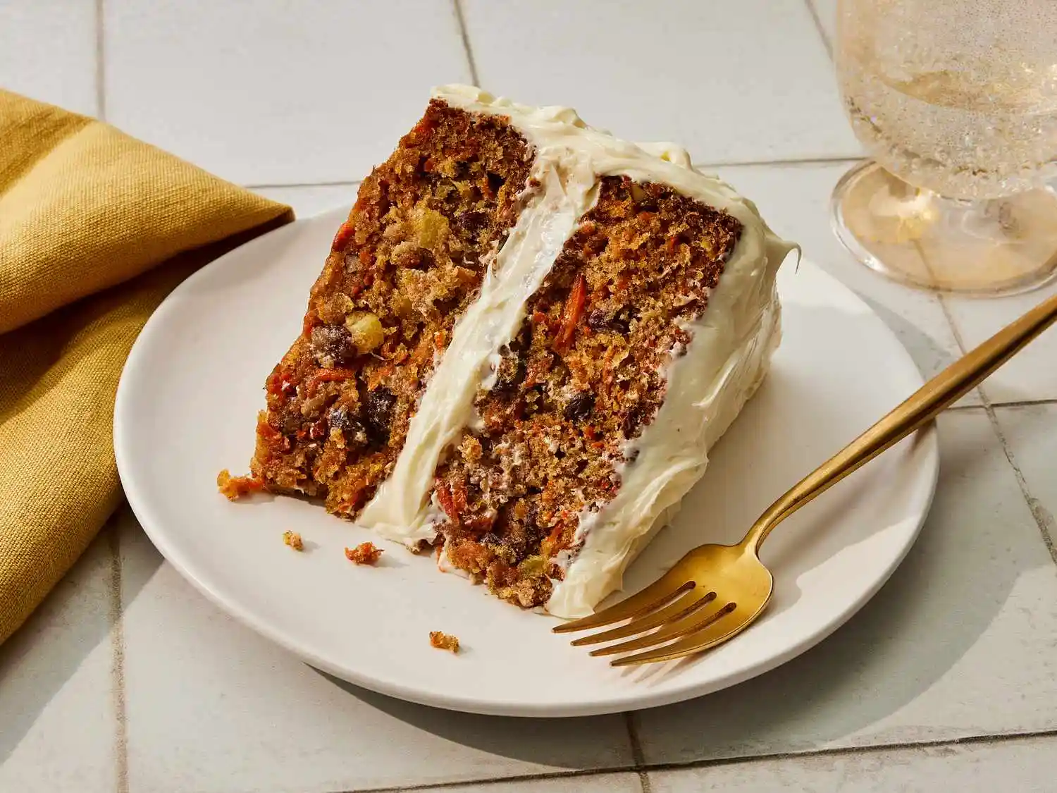 The Best Moist Carrot Cake Recipe with Pineapple and Raisins 2 A beautiful two-layer carrot cake frosted with velvety cream cheese frosting and decorated with chopped walnuts